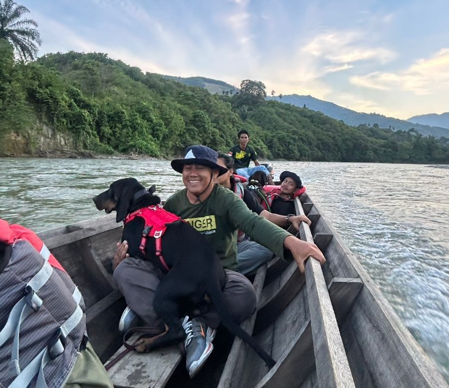 A partner river patrol team travelling by boat through the forest